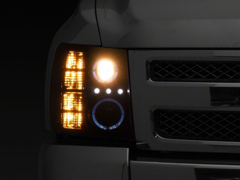 Raxiom 07-13 Chevrolet Silverado 1500 LED Halo Projector Headlights- Black Housing- Clear Lens